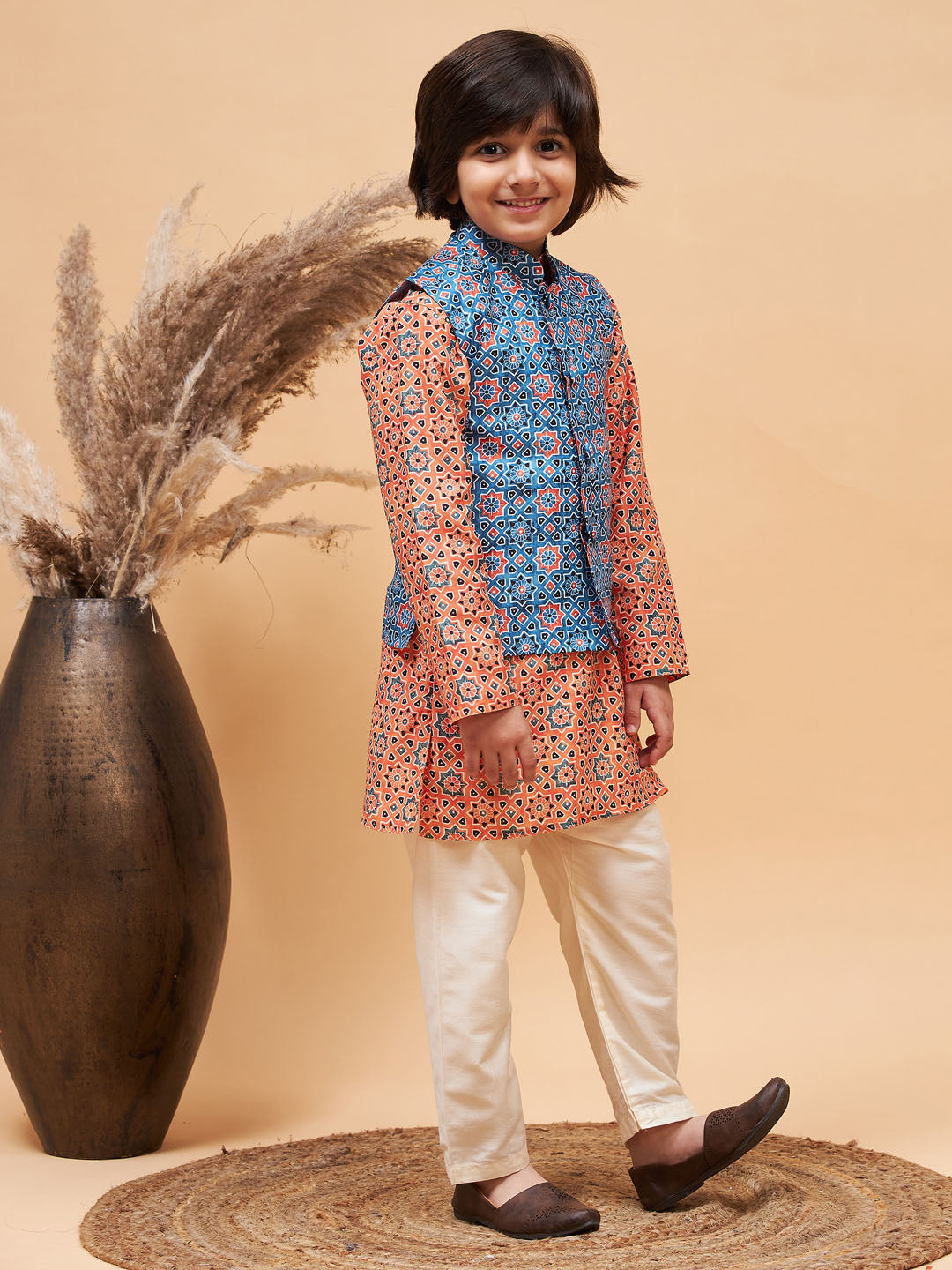 VASTRAMAY Boy's Orange Printed Kurta And Cream Pyjama Set With Blue Nehru Jacket - qivii