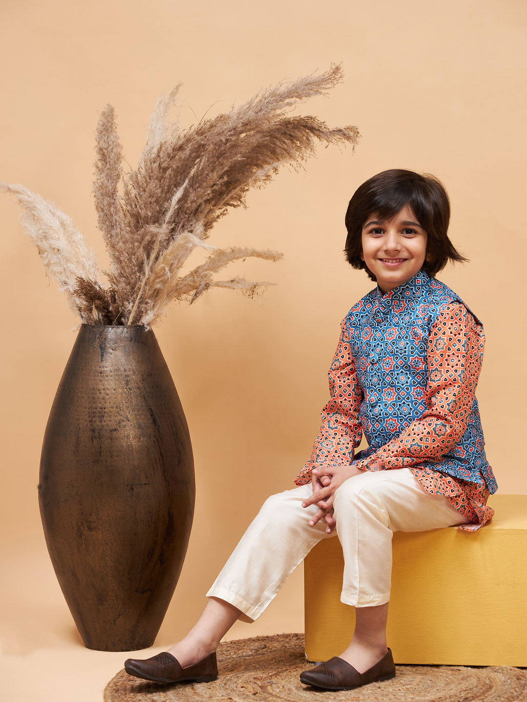VASTRAMAY Boy's Orange Printed Kurta And Cream Pyjama Set With Blue Nehru Jacket - qivii