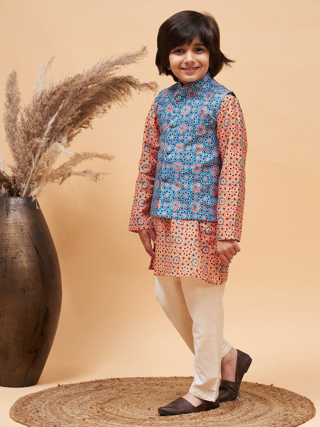 VASTRAMAY Boy's Orange Printed Kurta And Cream Pyjama Set With Blue Nehru Jacket - qivii